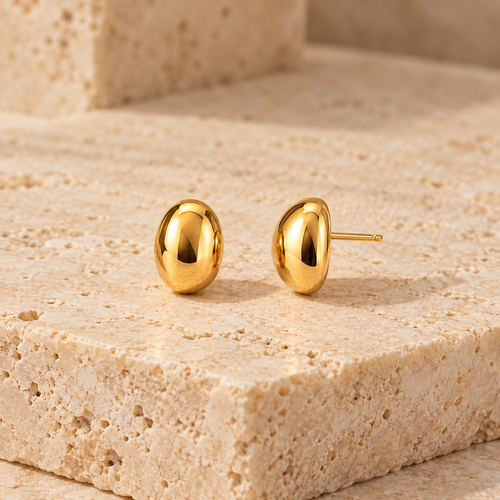 Céline Oval Studs displayed on a stone surface