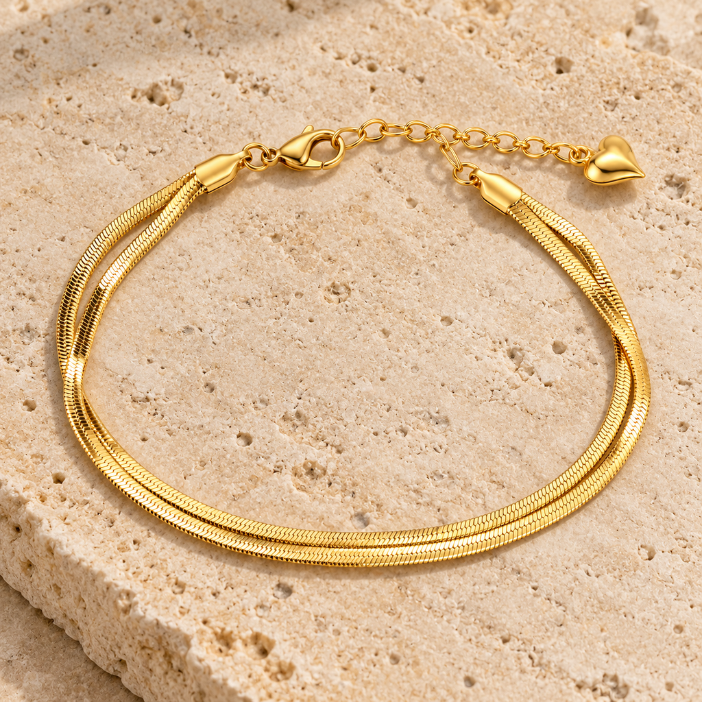 Double snake chain heart charm anklet worn on ankle