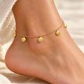 Gold-tone anklet with six seashell charms on beige stone
