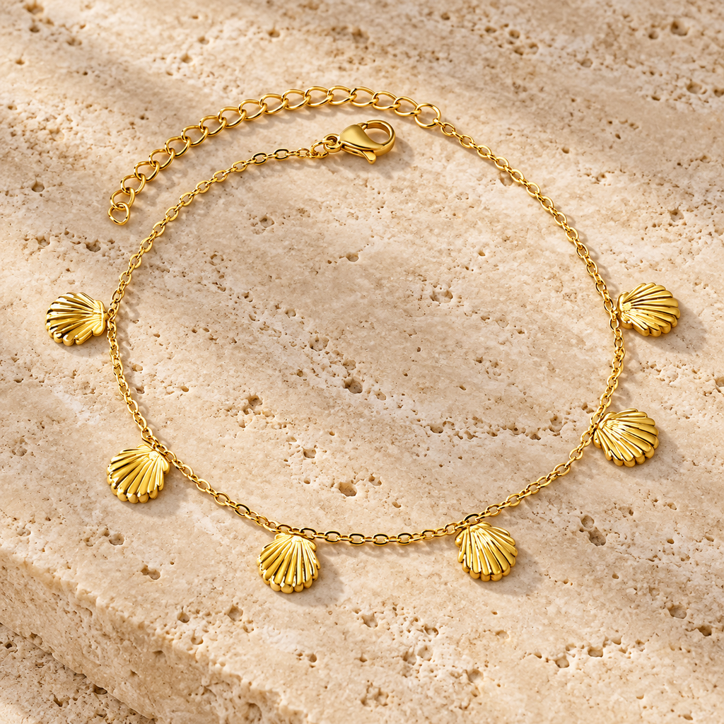 Gold-tone seashell charm anklet with lobster clasp and extender chain on white