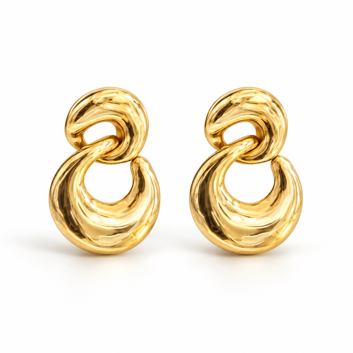 Pair of sculpted gold-tone double-link earrings displayed on stone