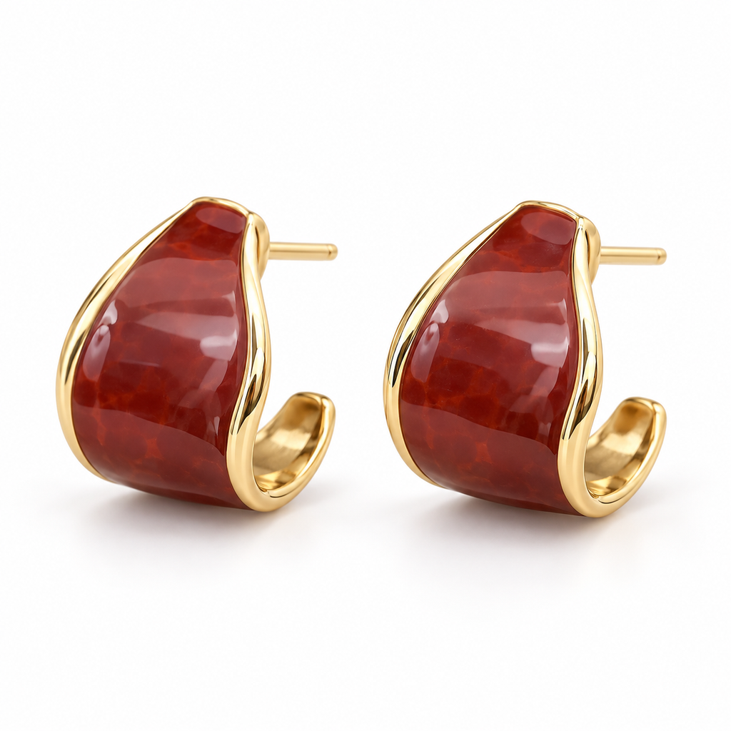 Reddish-brown and gold-tone curved hoop earring worn on ear
