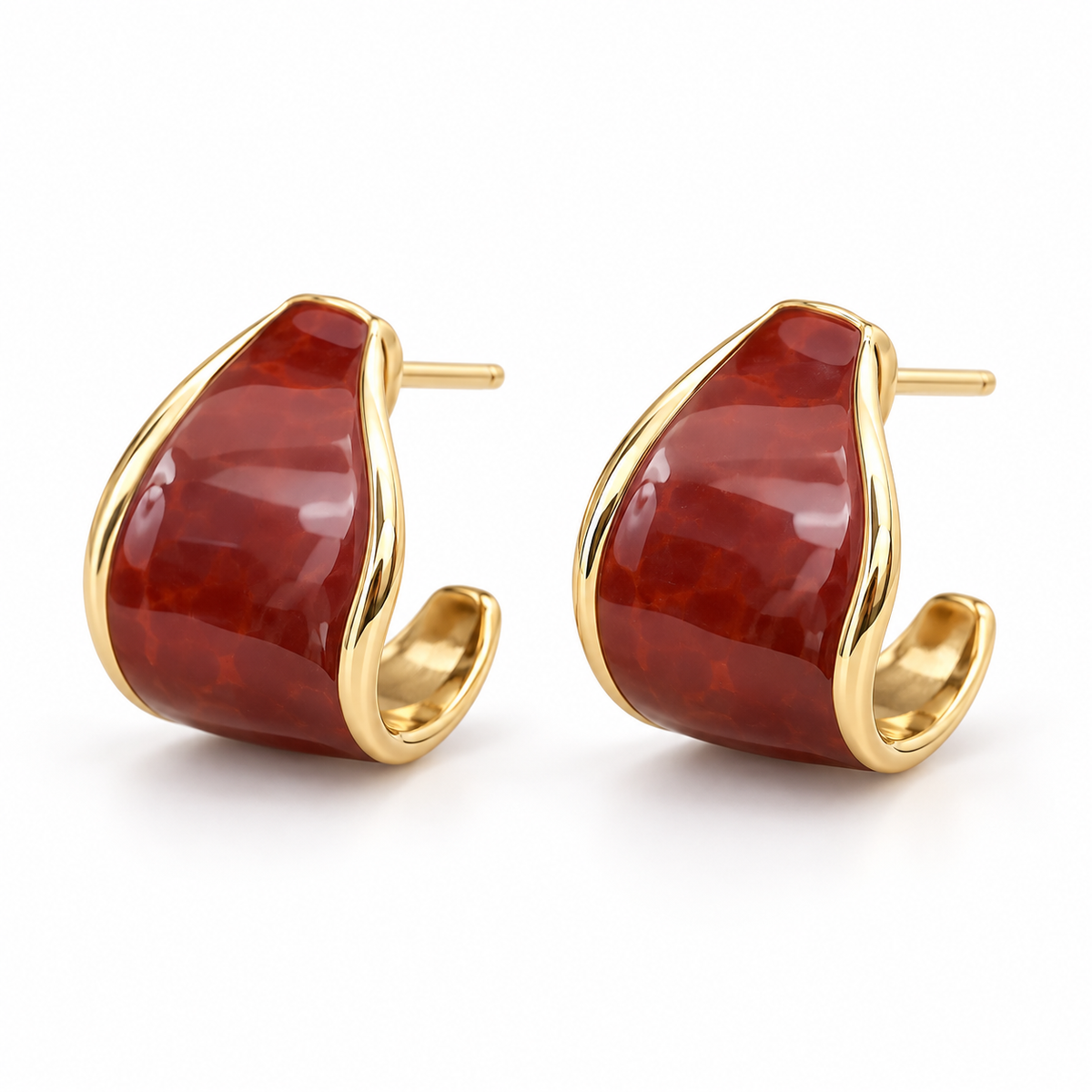 Reddish-brown and gold-tone curved hoop earring worn on ear